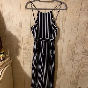 Moa jumpsuit. Navy blue and white stripes. Has pockets. Size small.